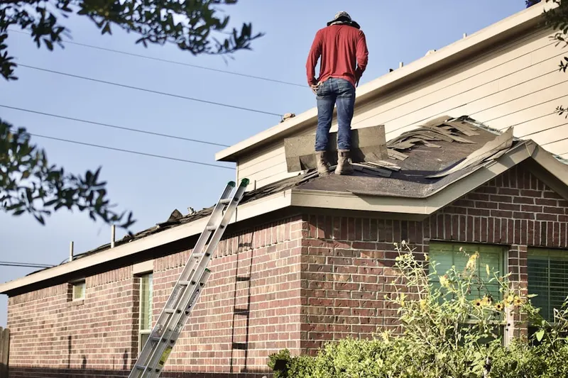 Professional roofer working on a residential roof in Fish Creek Station
